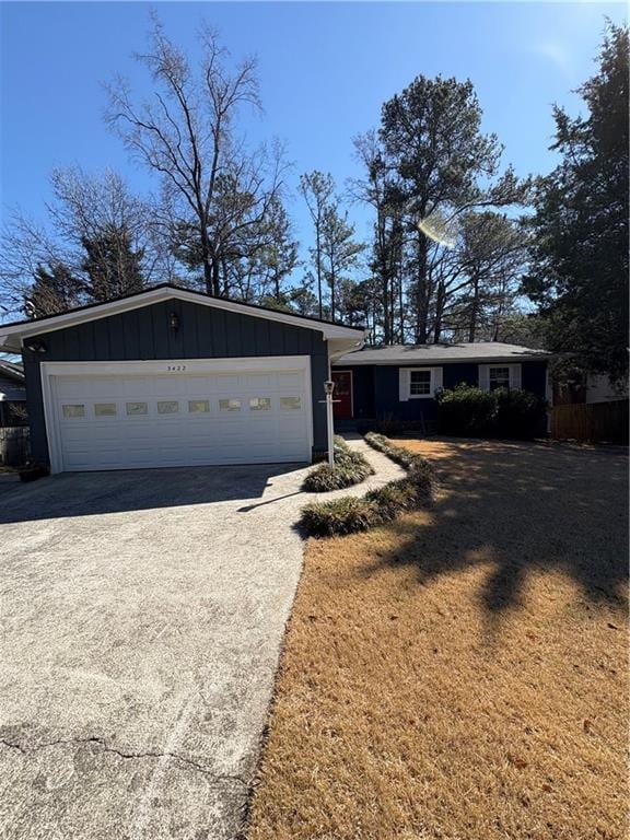 view of front of home with a garage, driveway, and board and batten siding