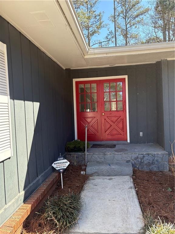 view of exterior entry with board and batten siding