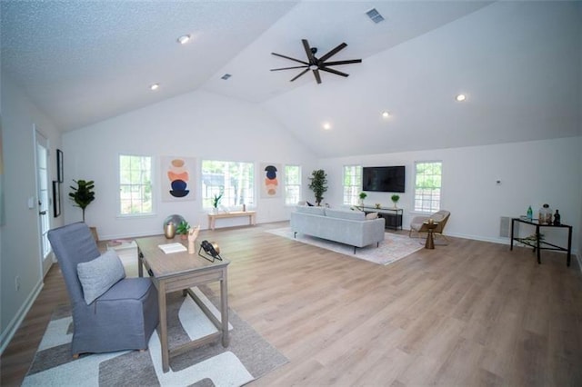 909 NE Otter Way NE, Marietta, GA 30068 - living area featuring vaulted ceiling, wood finished floors, ceiling fan, plenty of natural light, and recessed lighting