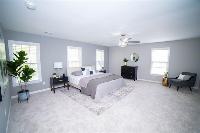 909 NE Otter Way NE, Marietta, GA 30068 - bedroom with multiple windows, light colored carpet, and ceiling fan