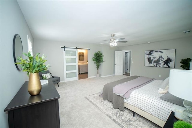 909 NE Otter Way NE, Marietta, GA 30068 - carpeted bedroom featuring a barn door, ceiling fan, and connected bathroom