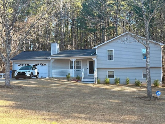 tri-level home featuring a porch and a garage