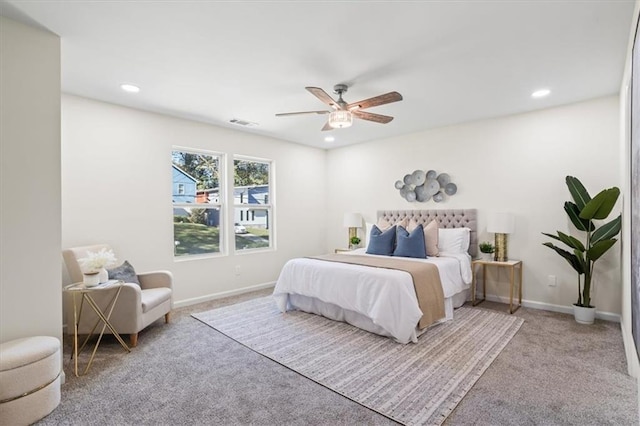 carpeted bedroom featuring ensuite bathroom and ceiling fan