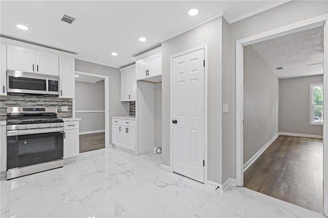 2310 Whitehead Place Dr, Suwanee, GA 30024 - kitchen with stainless steel appliances, backsplash, white cabinetry, light countertops, and recessed lighting