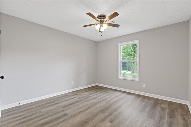2310 Whitehead Place Dr, Suwanee, GA 30024 - empty room featuring wood finished floors, ceiling fan, and a textured ceiling