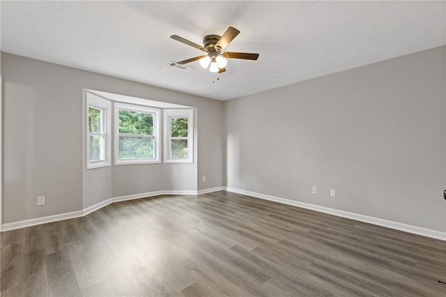 2310 Whitehead Place Dr, Suwanee, GA 30024 - unfurnished room featuring dark wood-style flooring, a ceiling fan, and a textured ceiling