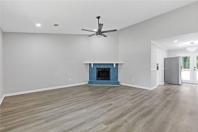 2310 Whitehead Place Dr, Suwanee, GA 30024 - unfurnished living room featuring ceiling fan, recessed lighting, wood finished floors, a fireplace, and french doors