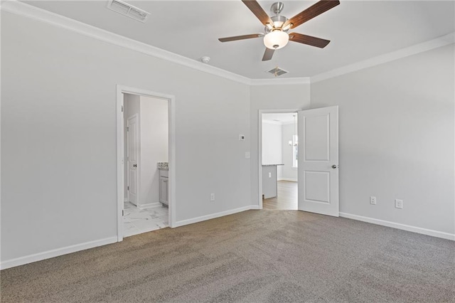 unfurnished bedroom with carpet floors, baseboards, ornamental molding, and visible vents