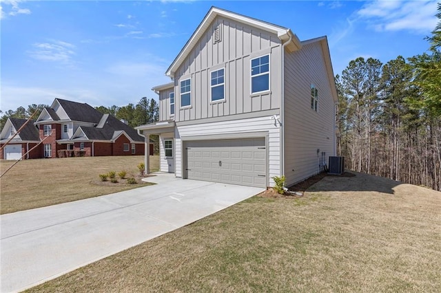 view of front of home with board and batten siding, an attached garage, a front lawn, and driveway