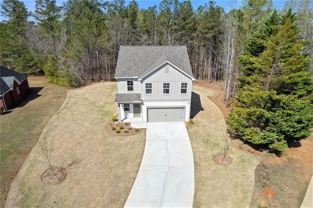 drone / aerial view with a wooded view