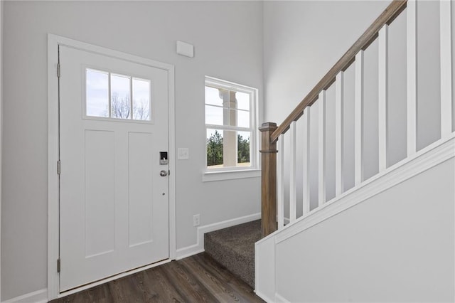 entryway featuring stairway, baseboards, and dark wood-style floors