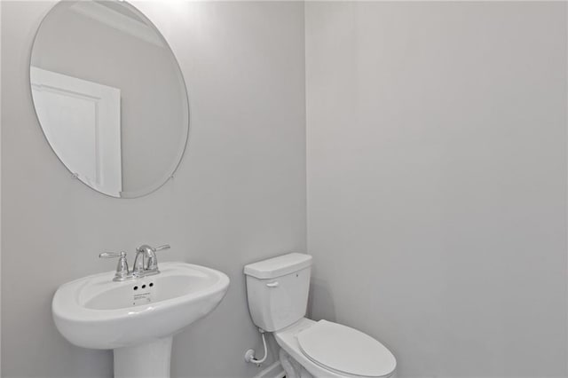 bathroom featuring toilet and a sink