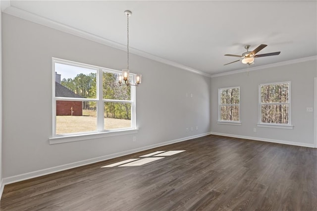 unfurnished dining area with dark wood finished floors, a wealth of natural light, and ornamental molding