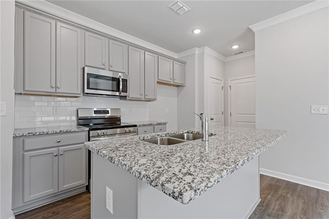 kitchen featuring gray cabinets, appliances with stainless steel finishes, a sink, and visible vents