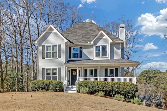 view of front facade featuring covered porch and a front lawn