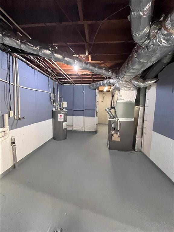 basement with water heater and heating unit