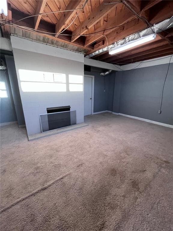 basement with carpet flooring and a fireplace