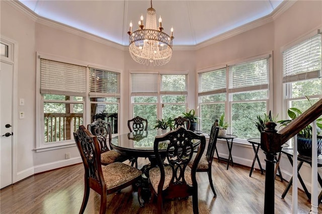 dining area featuring ornamental molding, baseboards, and wood finished floors