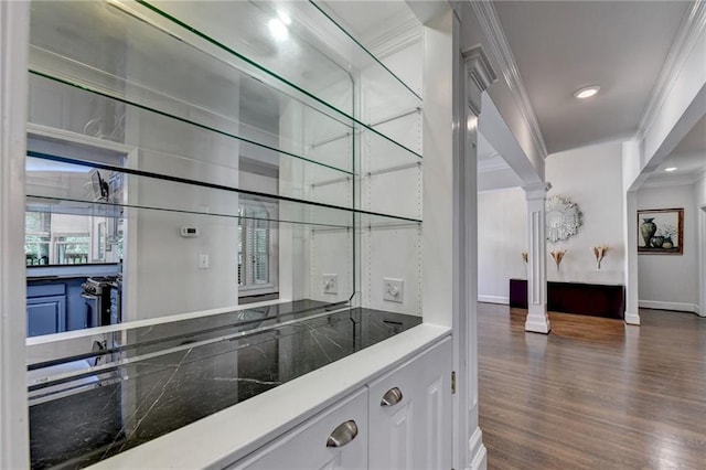 bar with recessed lighting, dark wood-style flooring, baseboards, ornate columns, and crown molding