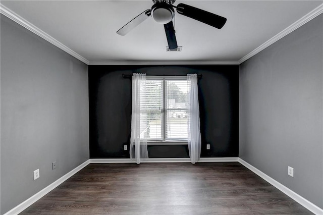 spare room featuring baseboards, wood finished floors, and ornamental molding