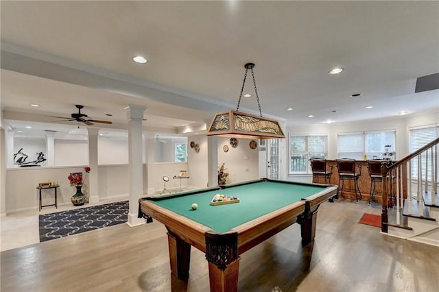 playroom featuring a wealth of natural light, recessed lighting, a bar, and wood finished floors