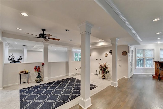 interior space featuring crown molding, recessed lighting, ornate columns, wood finished floors, and baseboards