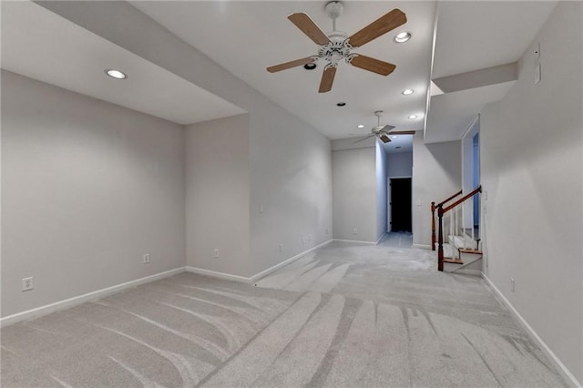 unfurnished living room featuring stairs, light carpet, baseboards, and recessed lighting