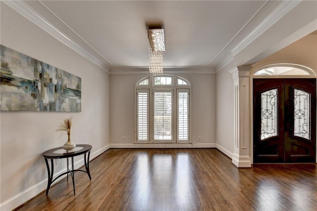 foyer entrance with ornamental molding, french doors, wood finished floors, and baseboards