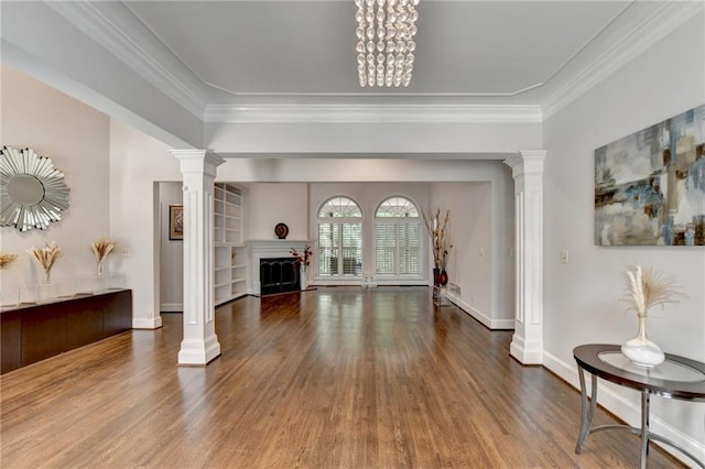 living room with a fireplace, wood finished floors, and decorative columns