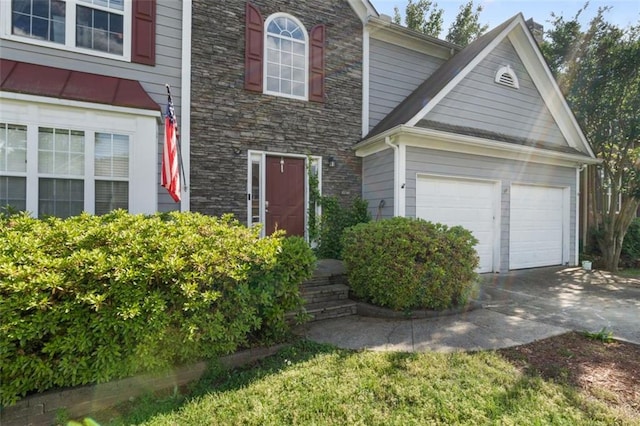 5077 Newpark Dr NW, Acworth, GA 30101 - view of front of home featuring concrete driveway, an attached garage, and stone siding