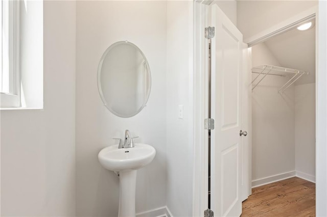 bathroom featuring wood finished floors and baseboards