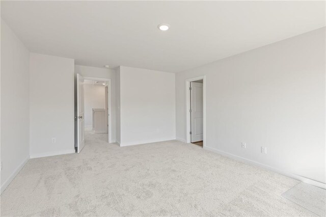 unfurnished bedroom featuring recessed lighting, baseboards, and light colored carpet