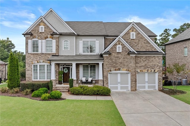 craftsman-style house with concrete driveway, brick siding, covered porch, and a front lawn