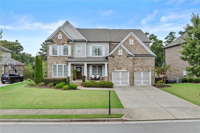 view of front of property featuring brick siding, driveway, an attached garage, and a front yard