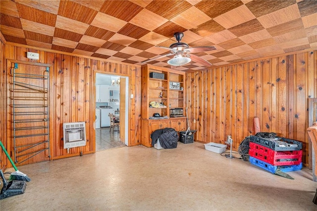 interior space featuring heating unit, wood walls, wooden ceiling, and washer / dryer