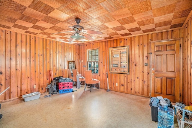 miscellaneous room featuring wooden ceiling, wood walls, baseboards, and ceiling fan