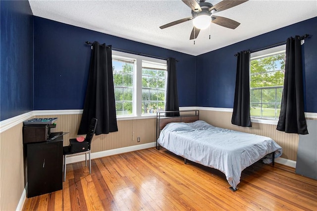 misc room featuring wood walls and a ceiling fan