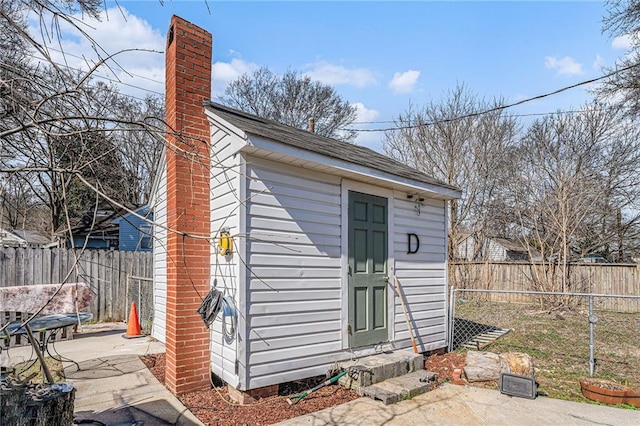 view of outbuilding featuring a fenced backyard and an outdoor structure