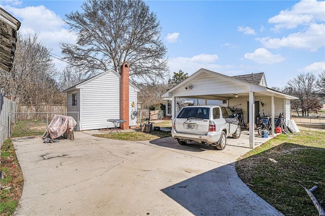 exterior space with concrete driveway and fence