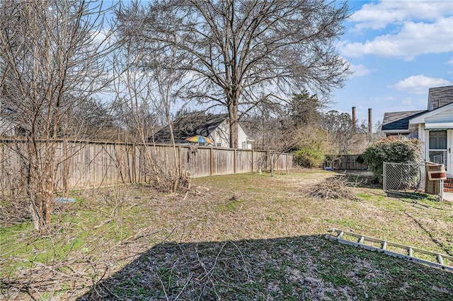 view of yard featuring central AC unit and a fenced backyard