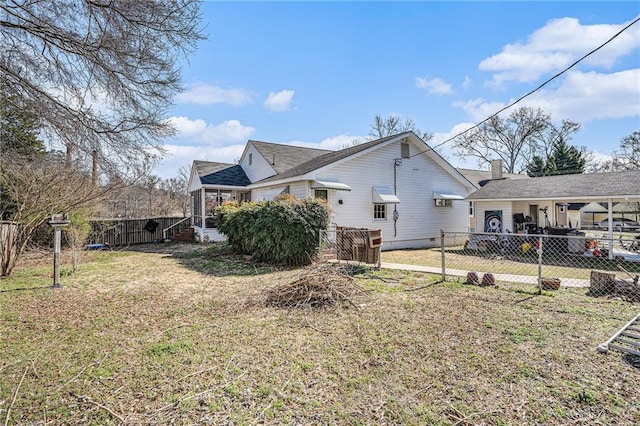 view of side of home with a fenced backyard and a yard