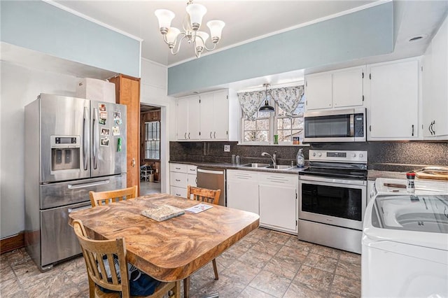 kitchen featuring crown molding, stainless steel appliances, decorative backsplash, white cabinets, and a sink