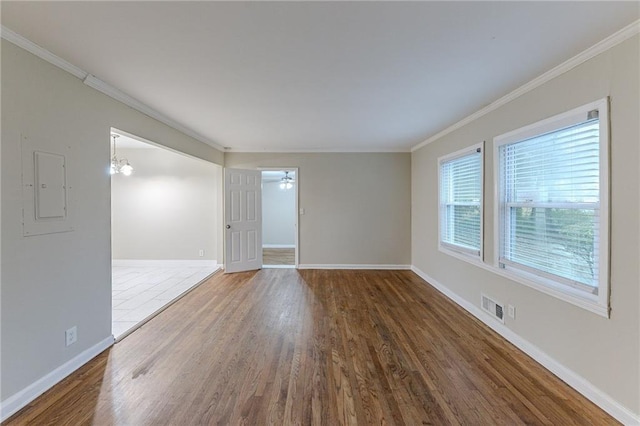 3147 Canary Ct, Decatur, GA 30032 - unfurnished room with ceiling fan with notable chandelier, electric panel, crown molding, and dark wood-type flooring