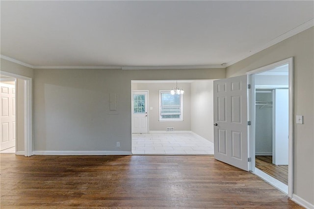 3147 Canary Ct, Decatur, GA 30032 - empty room with an inviting chandelier, crown molding, and hardwood / wood-style flooring
