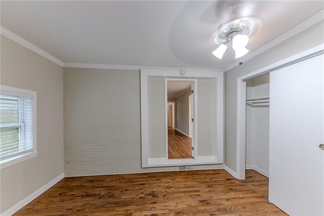 3147 Canary Ct, Decatur, GA 30032 - unfurnished bedroom featuring hardwood / wood-style flooring, brick wall, a closet, ornamental molding, and ceiling fan