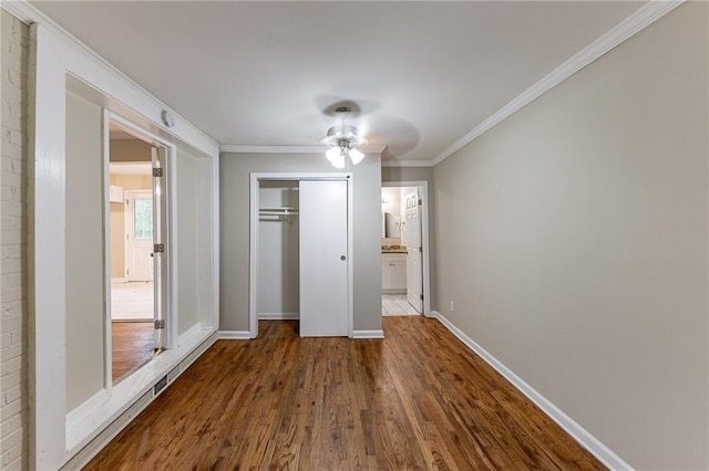 3147 Canary Ct, Decatur, GA 30032 - unfurnished bedroom with wood-type flooring, a closet, ceiling fan, and ornamental molding