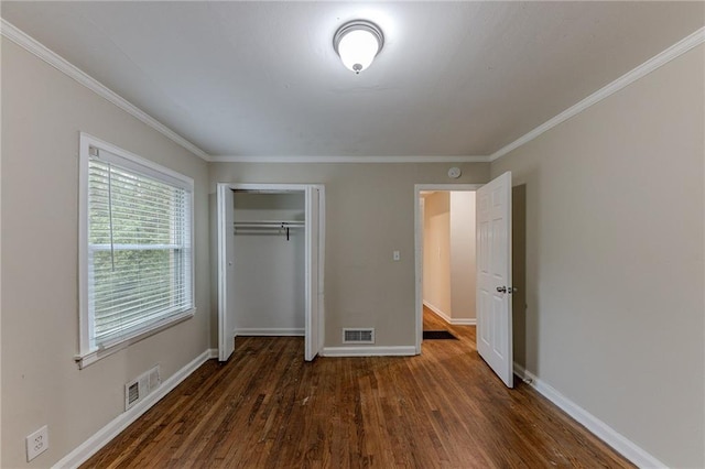 3147 Canary Ct, Decatur, GA 30032 - unfurnished bedroom with a closet, crown molding, and dark hardwood / wood-style floors