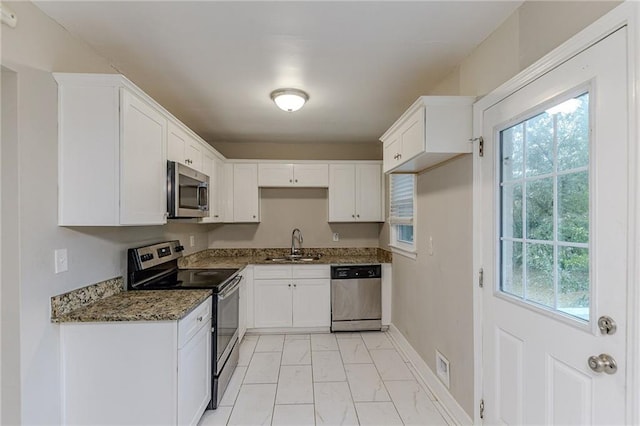 3147 Canary Ct, Decatur, GA 30032 - kitchen featuring sink, white cabinetry, dark stone counters, and appliances with stainless steel finishes
