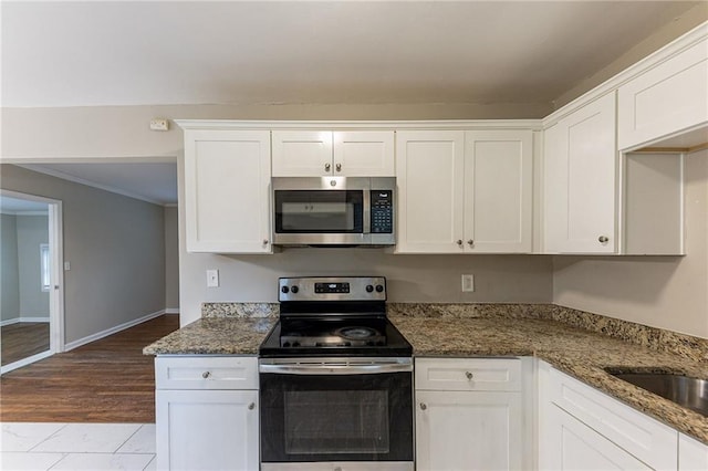 3147 Canary Ct, Decatur, GA 30032 - kitchen with appliances with stainless steel finishes, white cabinetry, and dark stone countertops