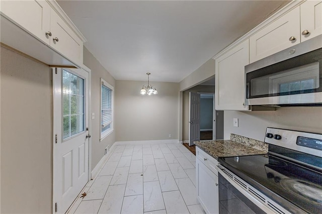 3147 Canary Ct, Decatur, GA 30032 - kitchen with stainless steel appliances, white cabinets, decorative light fixtures, dark stone countertops, and a notable chandelier
